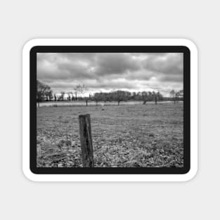 Wooden fence post in the English countryside Magnet