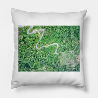 Aerial view of curvy mountain road through a jungle Pillow