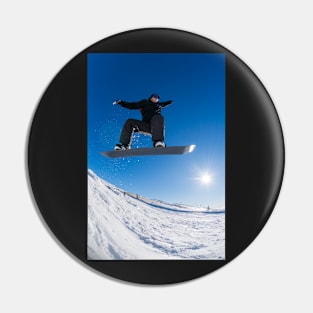 Snowboarder jumping against blue sky Pin