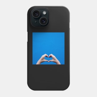 Love sign made by hands against a blue wall Phone Case
