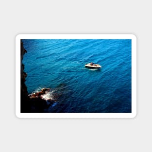 View from a high rocky shore of Polignano a Mare at a boat in the Adriatic sea Magnet