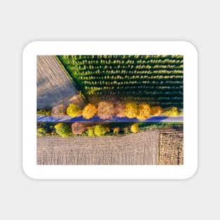 Aerial view of country road, autumn trees and ploughed field Magnet