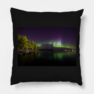 Northern lights glowing over lake in Finland Pillow