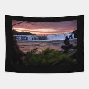 Man Watching Midnight Sunset by the Waterfall during Summer in Iceland Tapestry