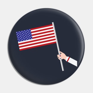 Woman hand holding USA flag Pin