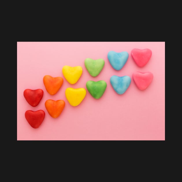 Heart-shaped Candy arranged in rainbow order on a pink background by karinelizabeth