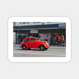 Red Morris 8 car in deco city of Napier New Zealand. Magnet