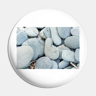 Stone in variety and colour on beach Pin