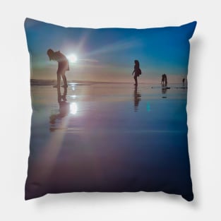 Copy of Silhouetted people in a row on a sand beach. Pillow