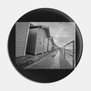 Row of traditional wooden beach huts on the Norfolk coast Pin