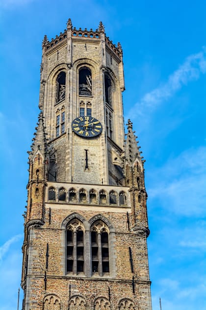 Belfry of Bruges against blue sky Kids T-Shirt by lena-maximova