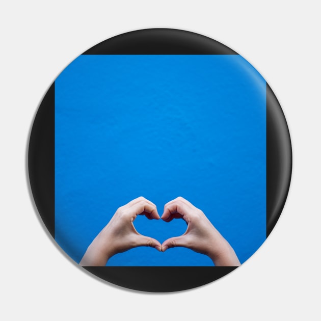 Love sign made by hands against a blue wall Pin by mooonthemoon