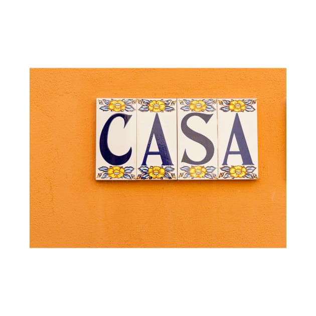 Village street in old Spanish town with Spanish word CASA in tiles on orange wall by brians101