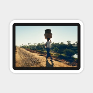 Woman Carrying Baskets on Head Walking in Burmese Countryside in Beautiful Morning Light Magnet