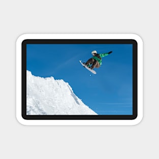 Snowboarder jumping against blue sky Magnet