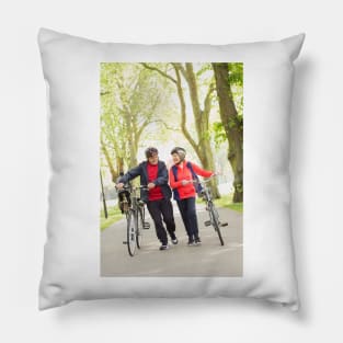 Active senior couple walking bicycles in park (F023/0128) Pillow