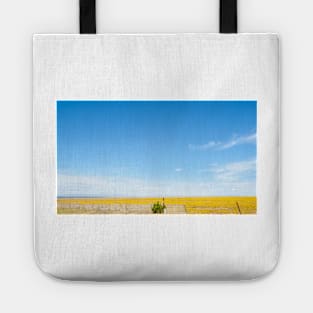 Bright yellow flowers of grass crop in rural USA Tote