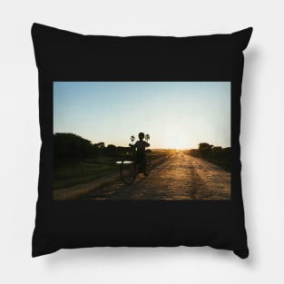 Silhouette of Boy Riding Bicycle at Sunset in Burmese Countryside Pillow