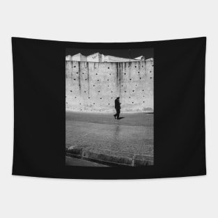 Man Walking Past Ancient City Wall Tapestry