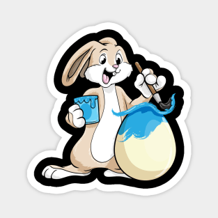 Funny bunny is painting an easter egg Magnet