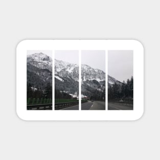 A shot on the move from the windshield of an electric car with a snow-covered alps mountain in front of it in a cold cloudy winter day. POV first person view shot on a mountain highway. Magnet