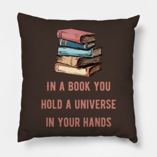 In a book you hold a universe in your hands pink text Pillow