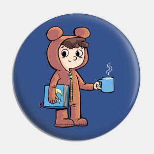 boy prepares for bed with a cup of warm milk and a picture book Pin