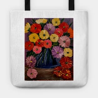 A  lovely boutique of abstract mixed flowers  in a blue vase . Tote