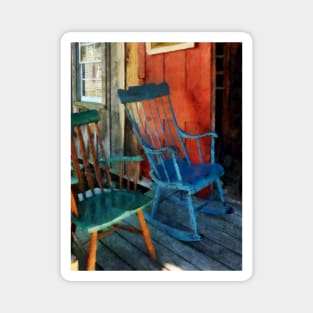 Blue and Green Rocking Chairs Against Red Door Magnet