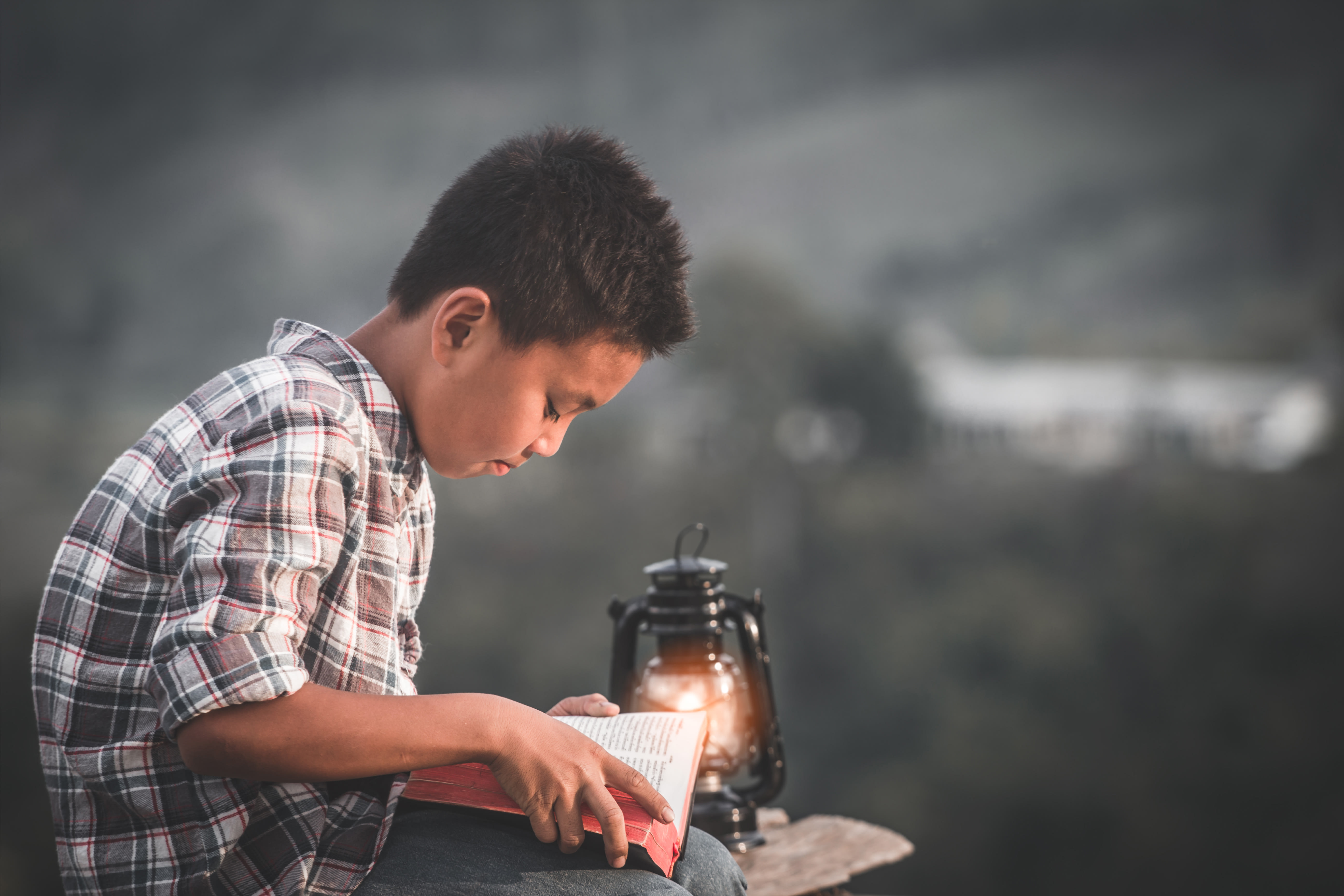 a boy reading Scripture