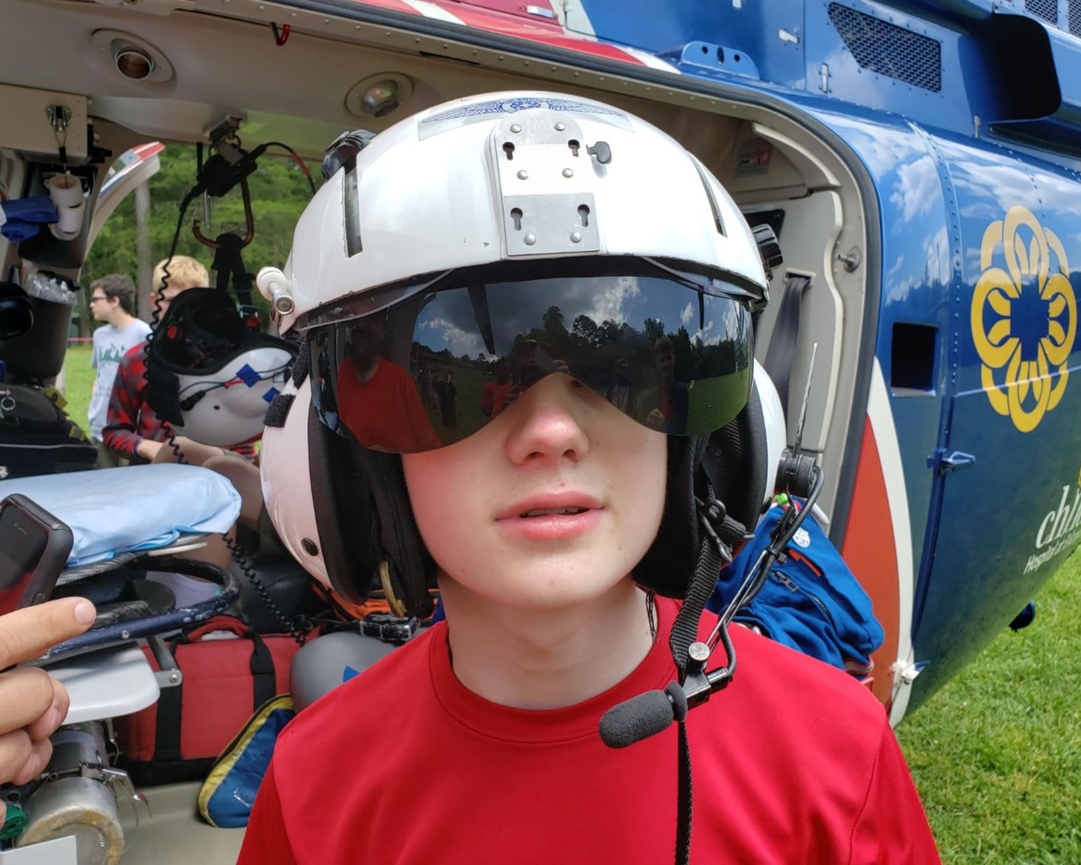 Mason wears the helmet of a helicopter pilot on a visit to Woodruff Scout Camp.