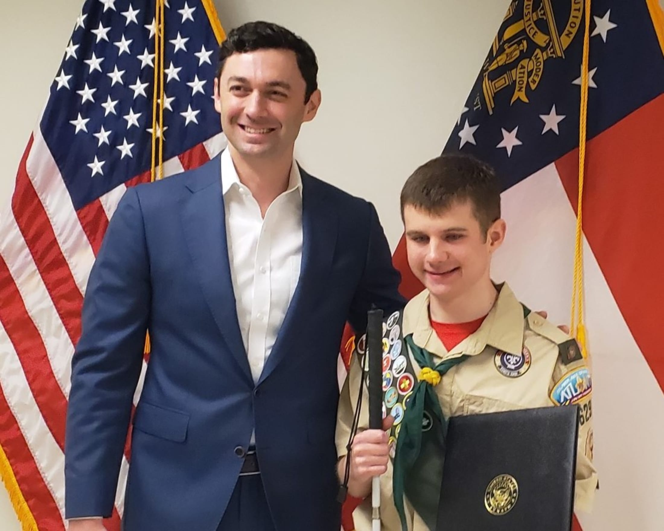Mason and Senator Jon Ossoff pose for a photo after being presented a special recognition for earning his Eagle Scout award.