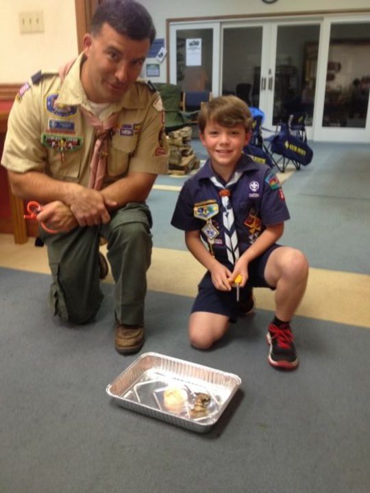 Like Father, Like Son. Learning how to use flint and steel to light a campfire.