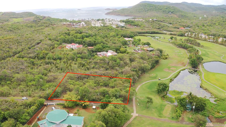 Aerial view; view facing east towards Cas en Bas beach with Golf Course to the left