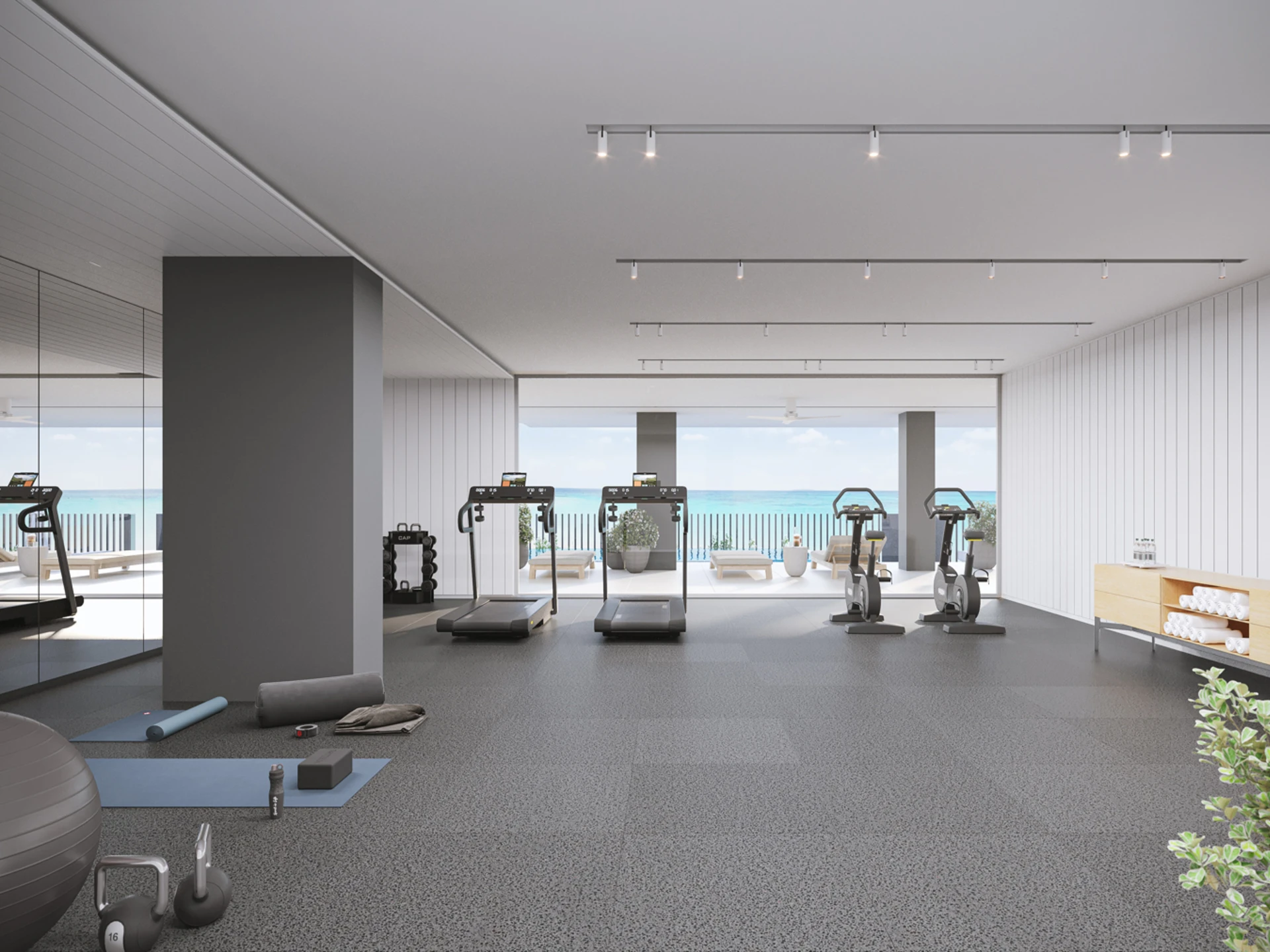Gym with large sea-facing windows.