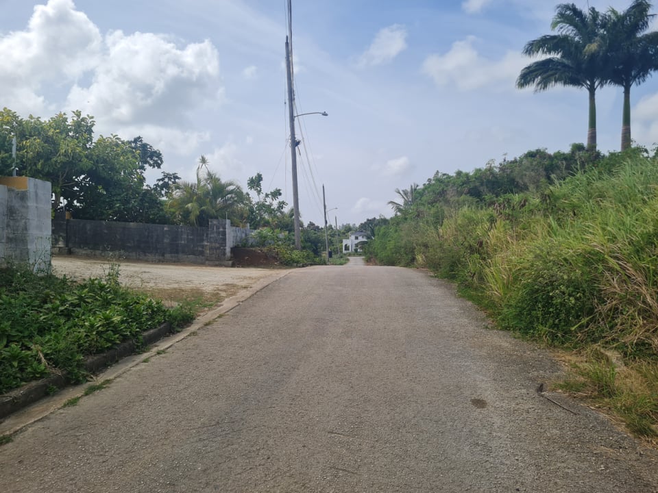 View of development road looking West towards public main road