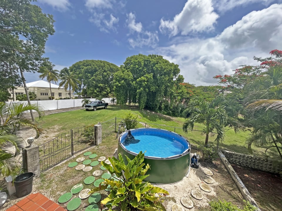 Surrounded by mature trees and garden area