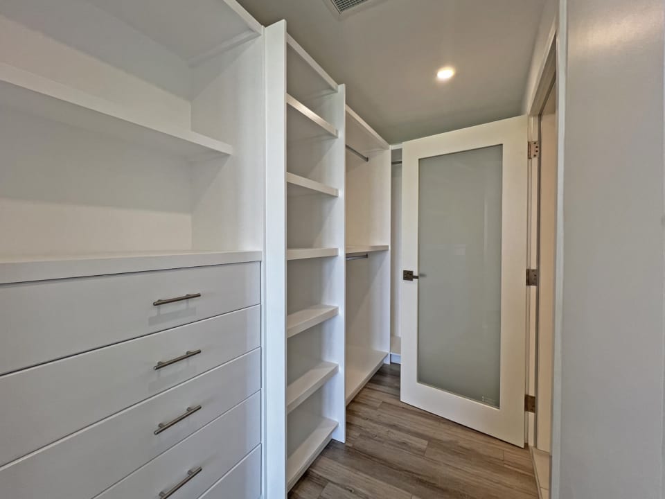 Walk in closet in the primary bedroom