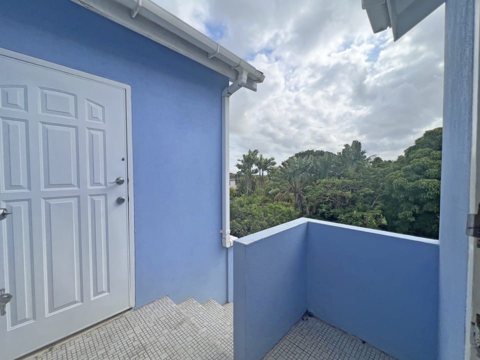 Door from the kitchen that leads to the shared laundry room