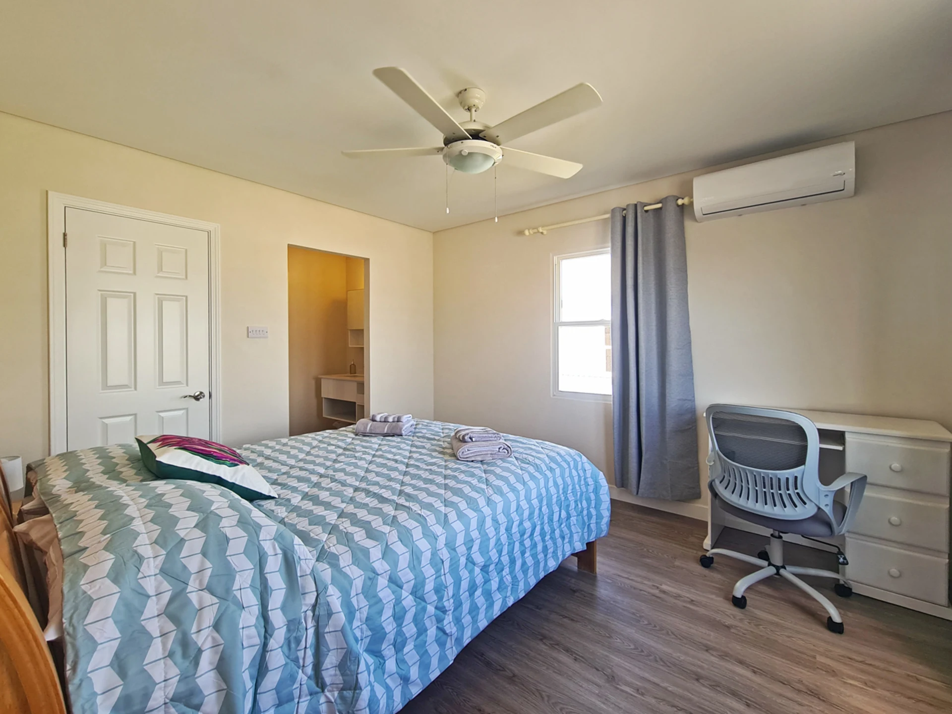 Primary bedroom with a walk in closet and ensuite bathroom