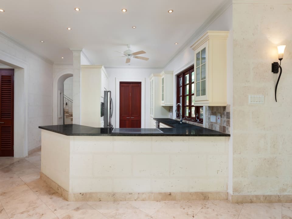 Large fitted kitchen leading to the laundry room