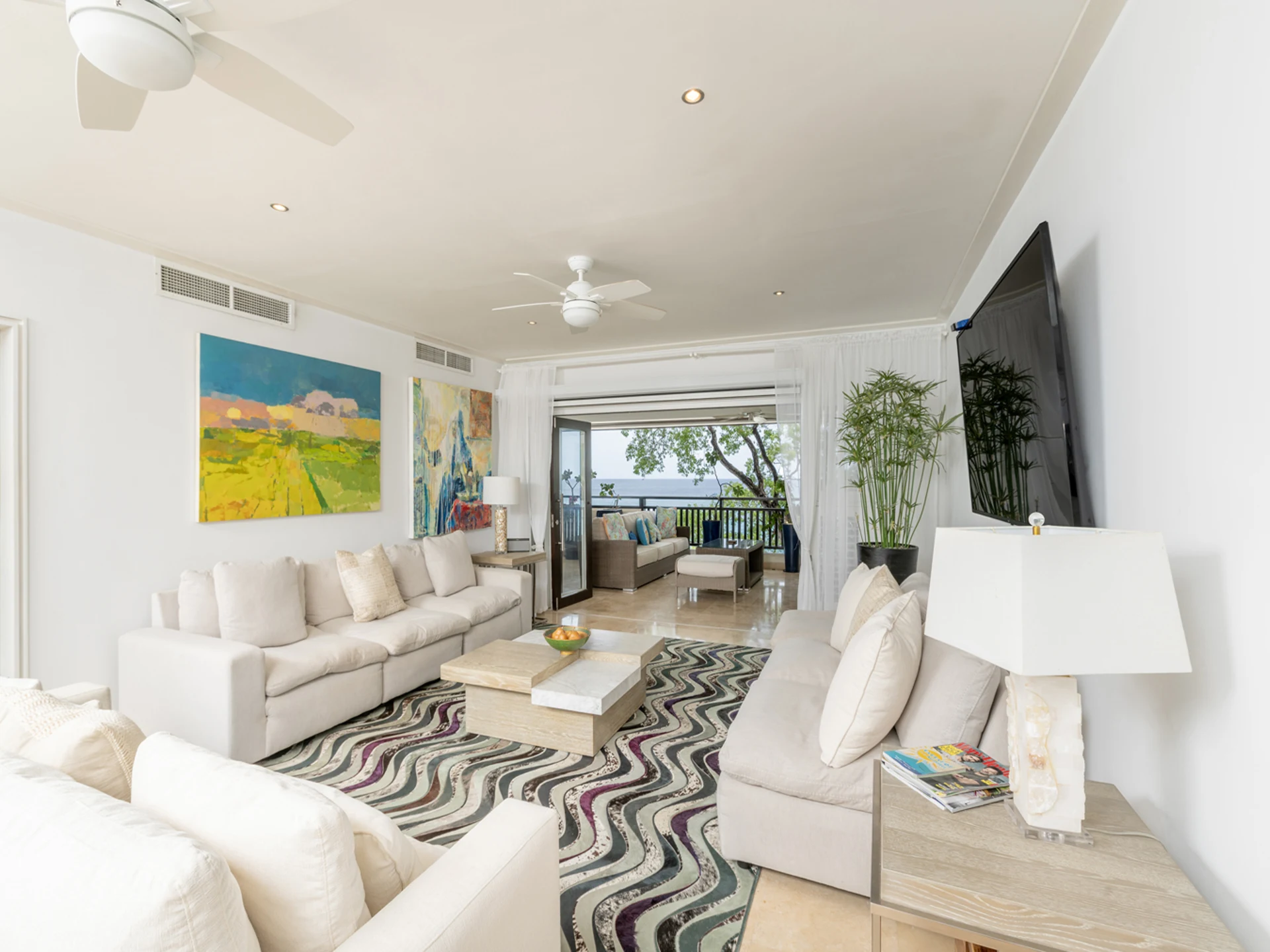 Open plan living room leading to the patio terrace