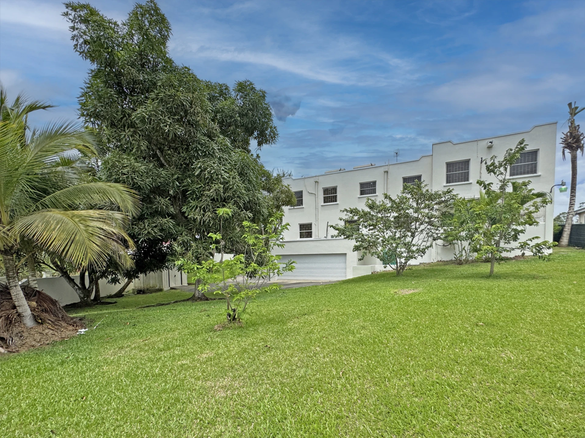 View of garage and lawn at back of house