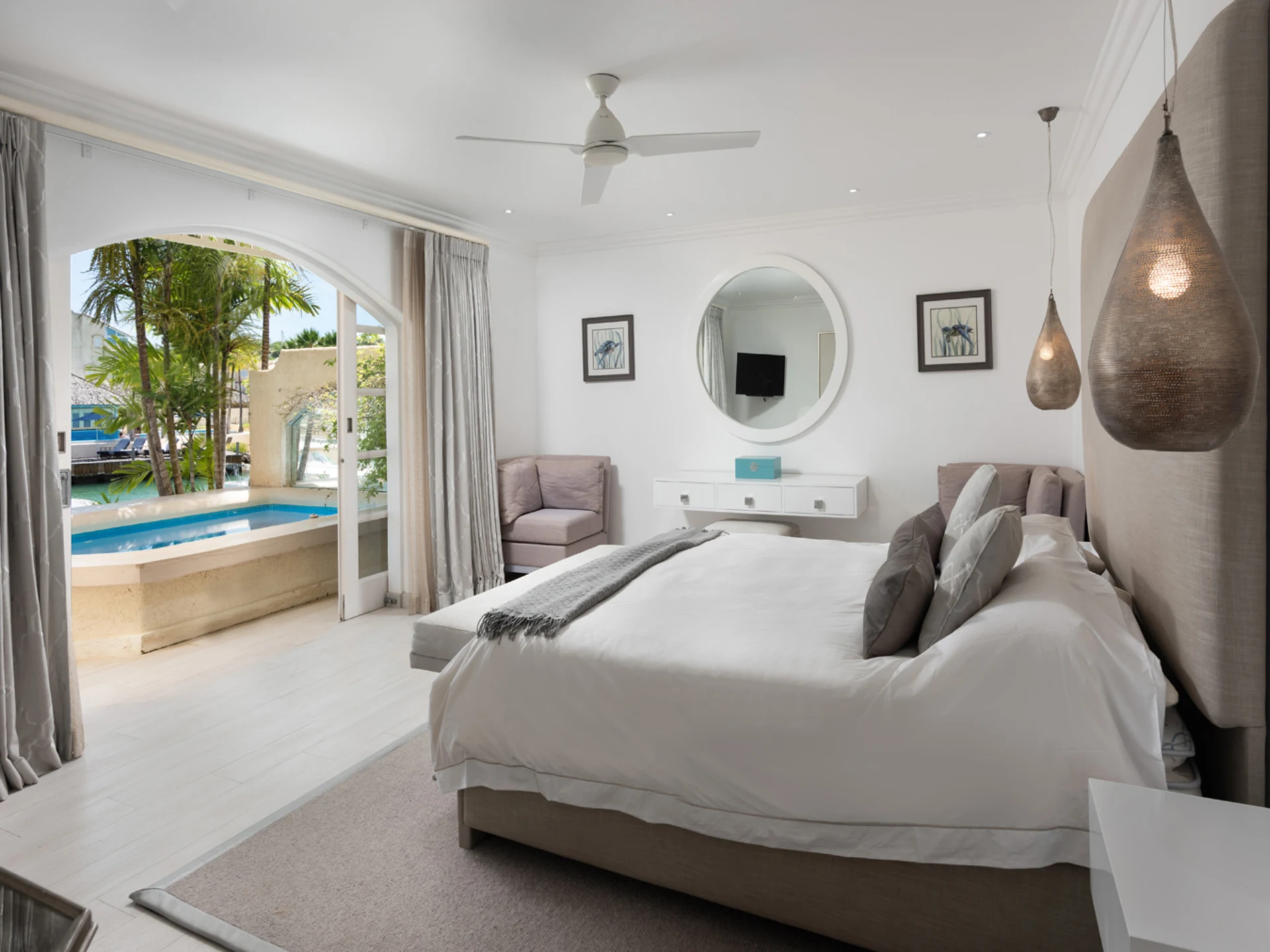 The primary suite opens out to the pool terrace
