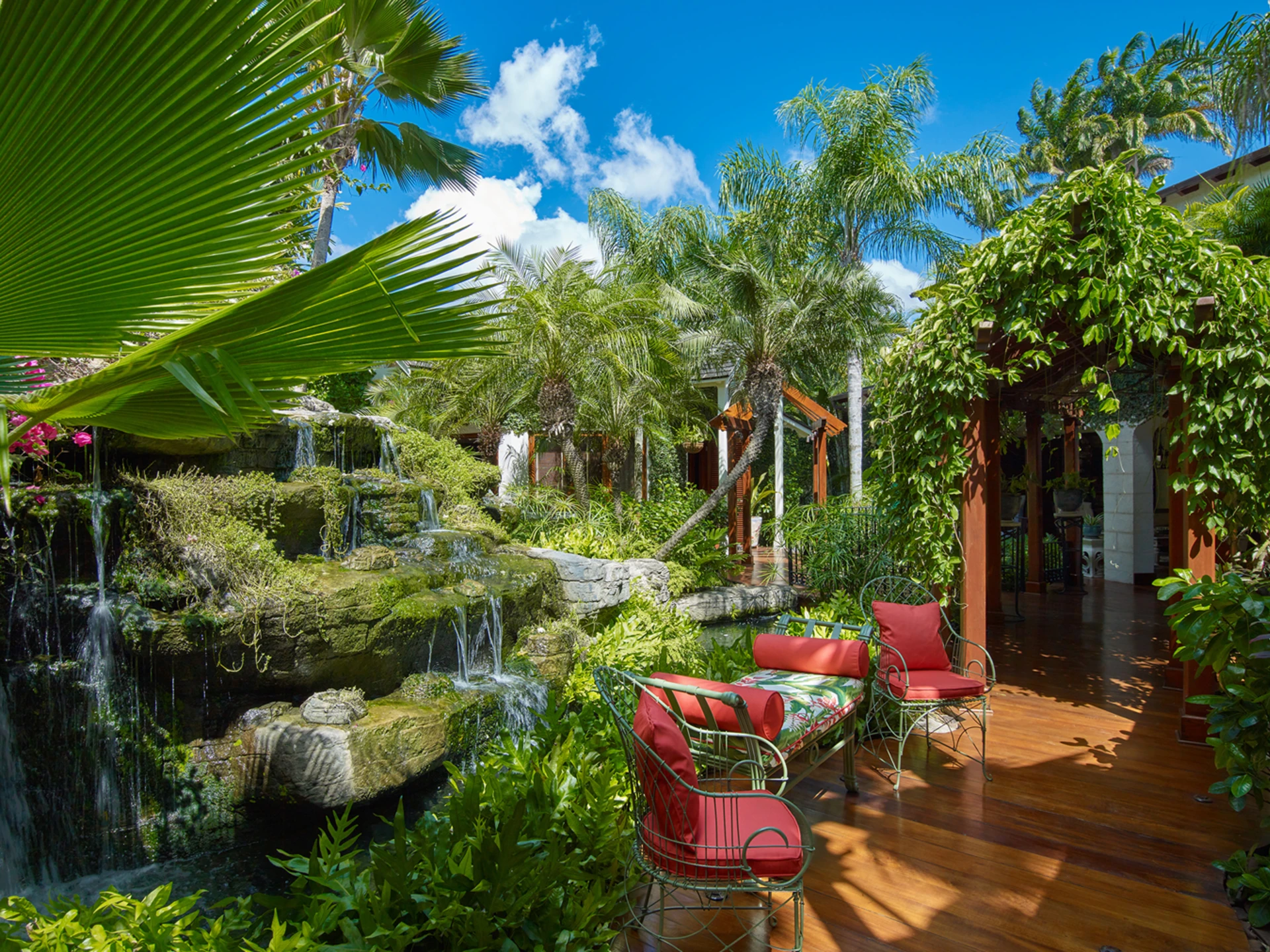 Beautiful gardens with waterfall lined with teak walkways