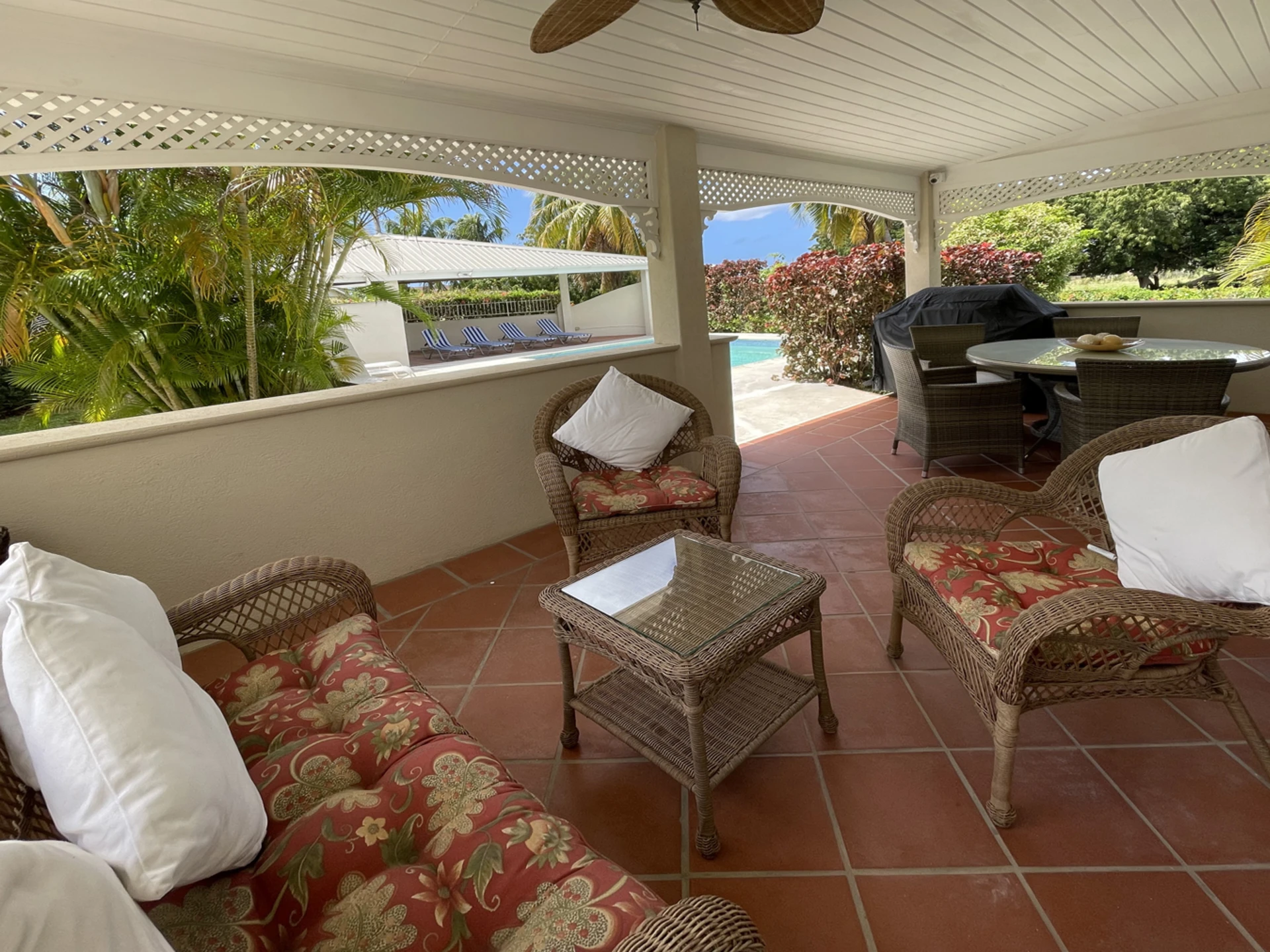 Covered verandah leads to swimming pool deck