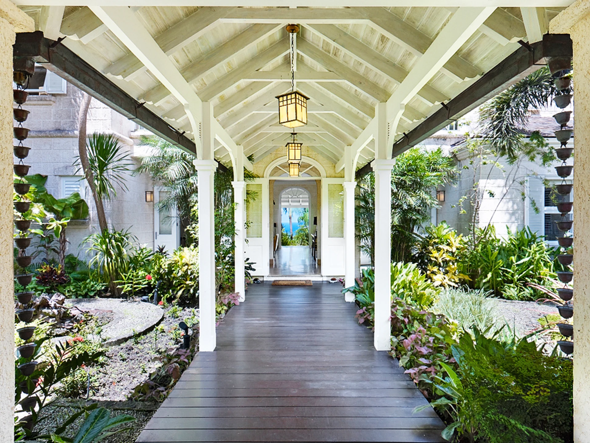 Covered entrance walkway through the tropical gardens