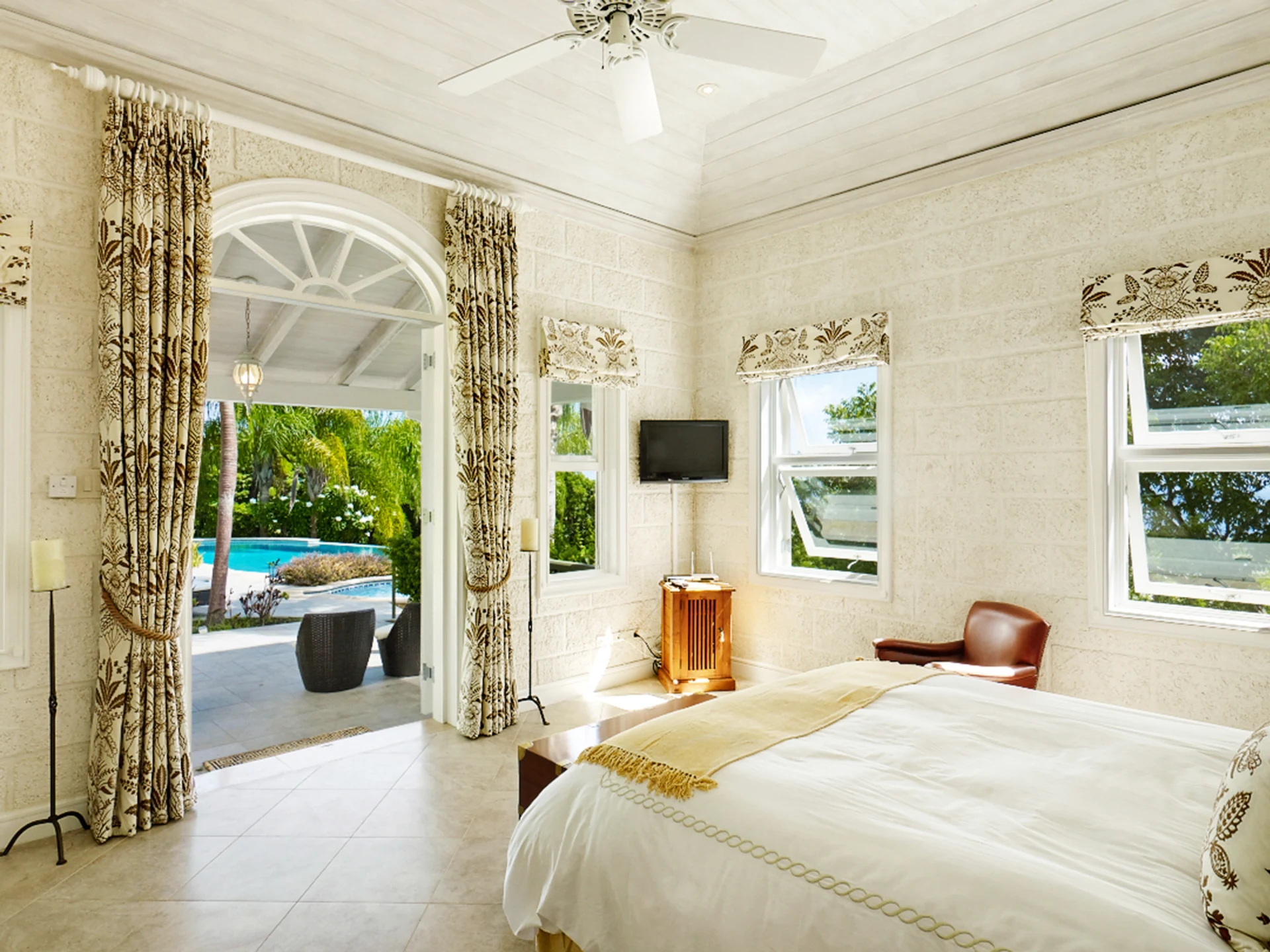 Ground floor bedroom opens to a balcony and swimming pool