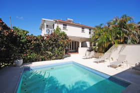 View of pool deck and house
