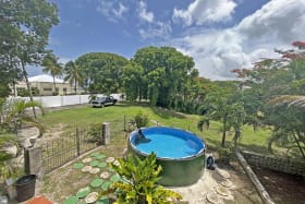 Surrounded by mature trees and garden area
